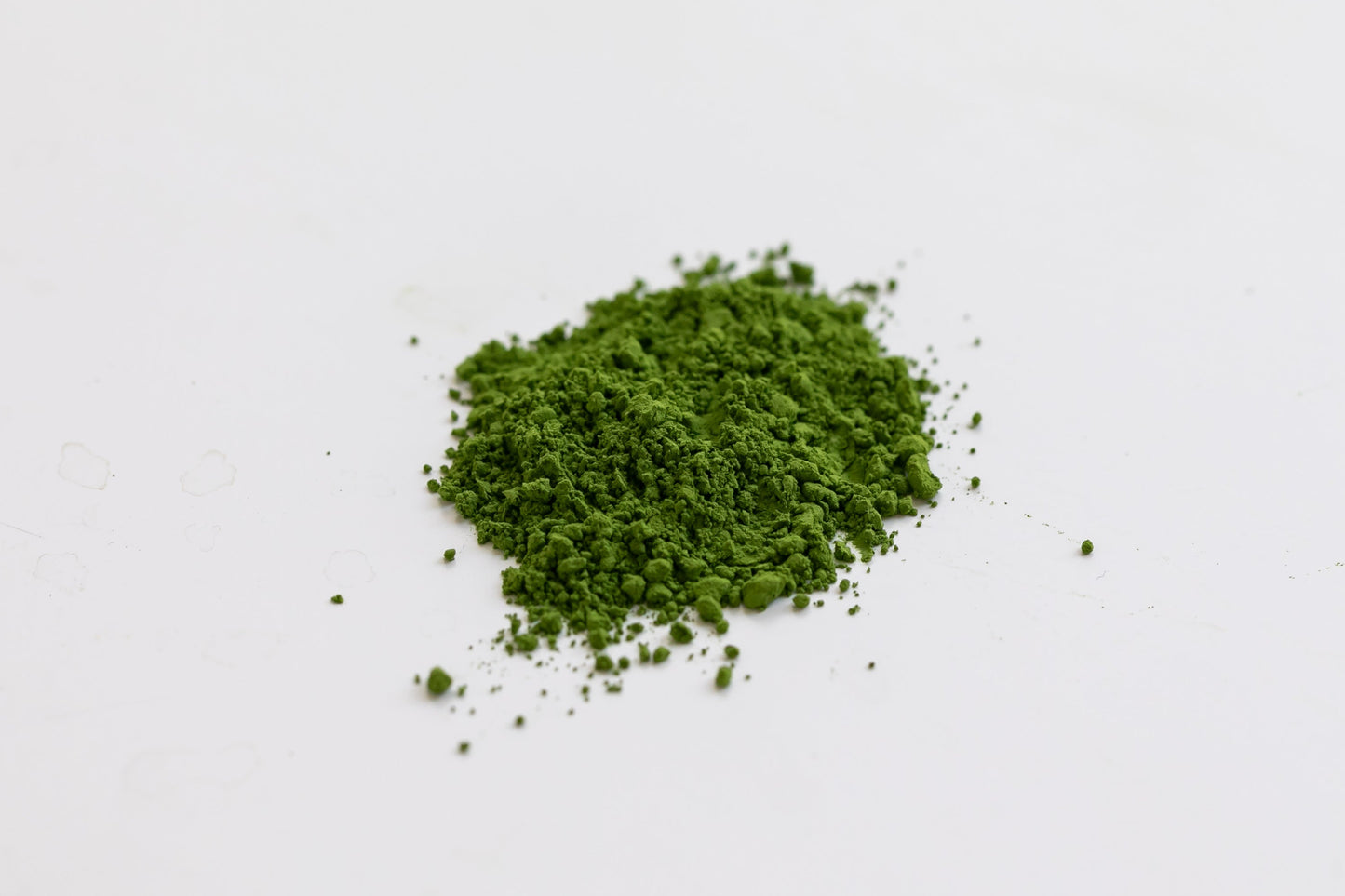 Green powder on a white background